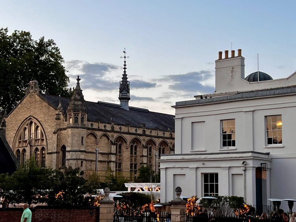 Historic Cheltenham buildings and outdoor seating at dusk