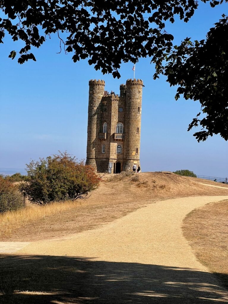 Broadway Tower in the Cotswolds, Worcestershire, viewed along the path beneath overhanging trees