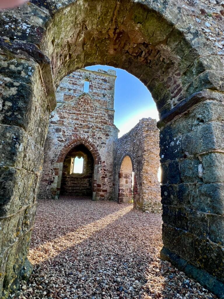 Stone arches and ruined interior of Knowlton Church in Dorset