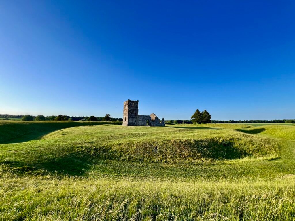Knowlton Church surrounded by the circular grassy earthworks of the prehistoric henge
