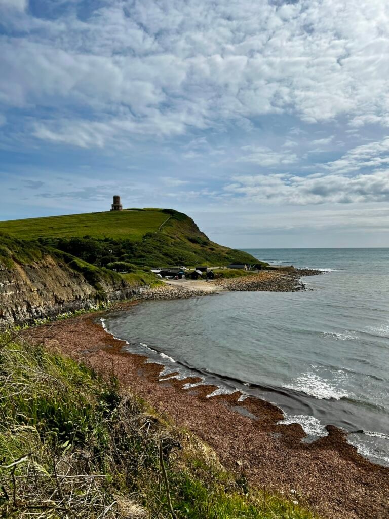 Clavell Tower standing on the grassy headland above Kimmeridge Bay in Dorset