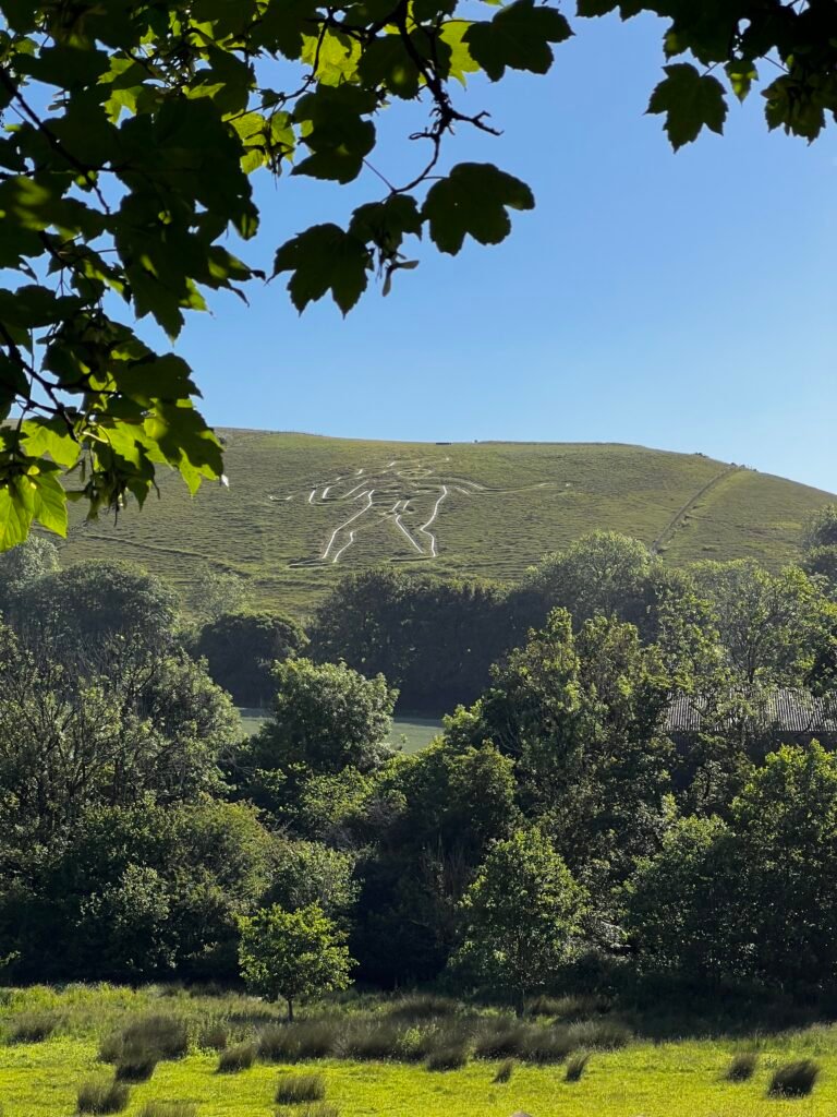 Cerne Abbas Giant chalk figure on a Dorset hillside above the surrounding countryside