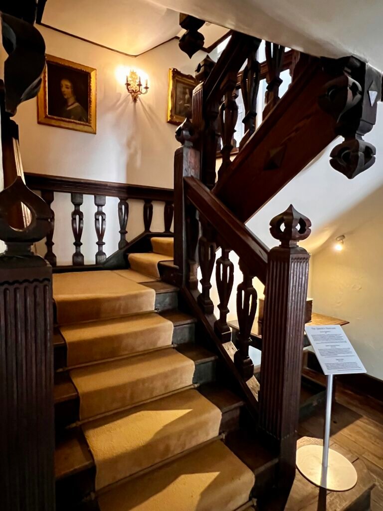 Carved wooden staircase inside Athelhampton House in Dorset