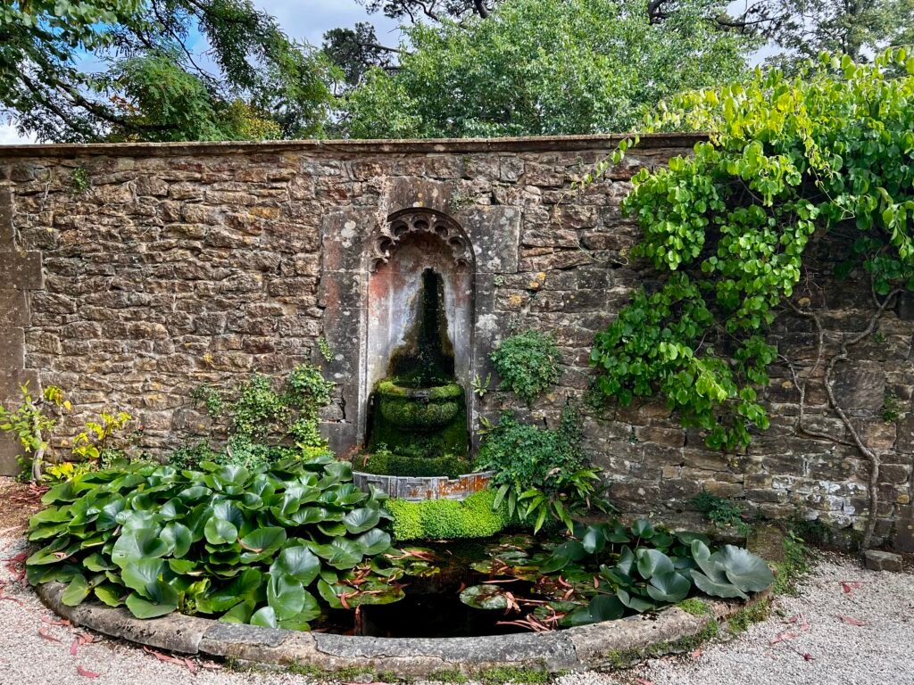 Historic stone water feature and lily pond in the gardens at Athelhampton House