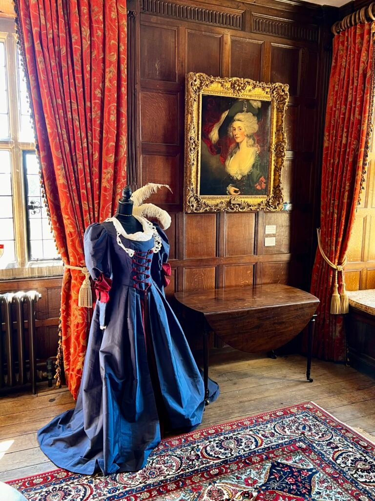 Period dress displayed inside historic Chawton House in Hampshire