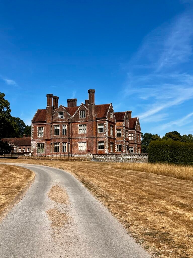 Breamore House in Hampshire with its red-brick façade and a curving driveway