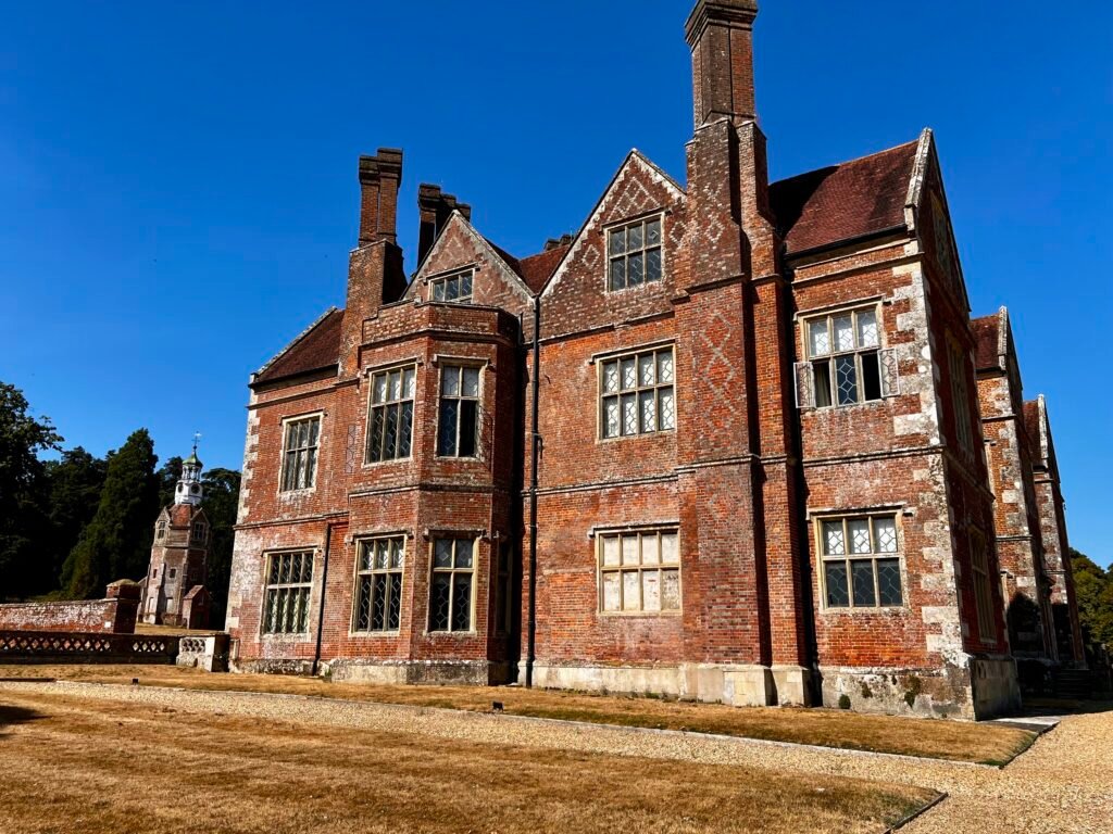 Historic red-brick exterior of Breamore House in Hampshire