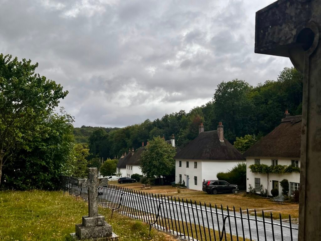 Whitewashed thatched cottages along the village street in Milton Abbas Dorset