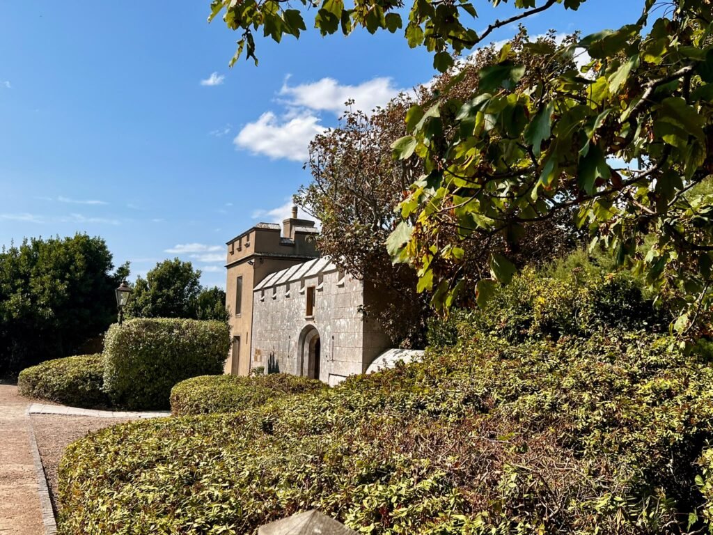 Portland Castle seen through trees and hedges in the garden