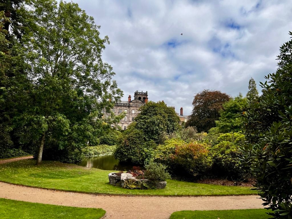 Historic country house seen through a landscaped garden