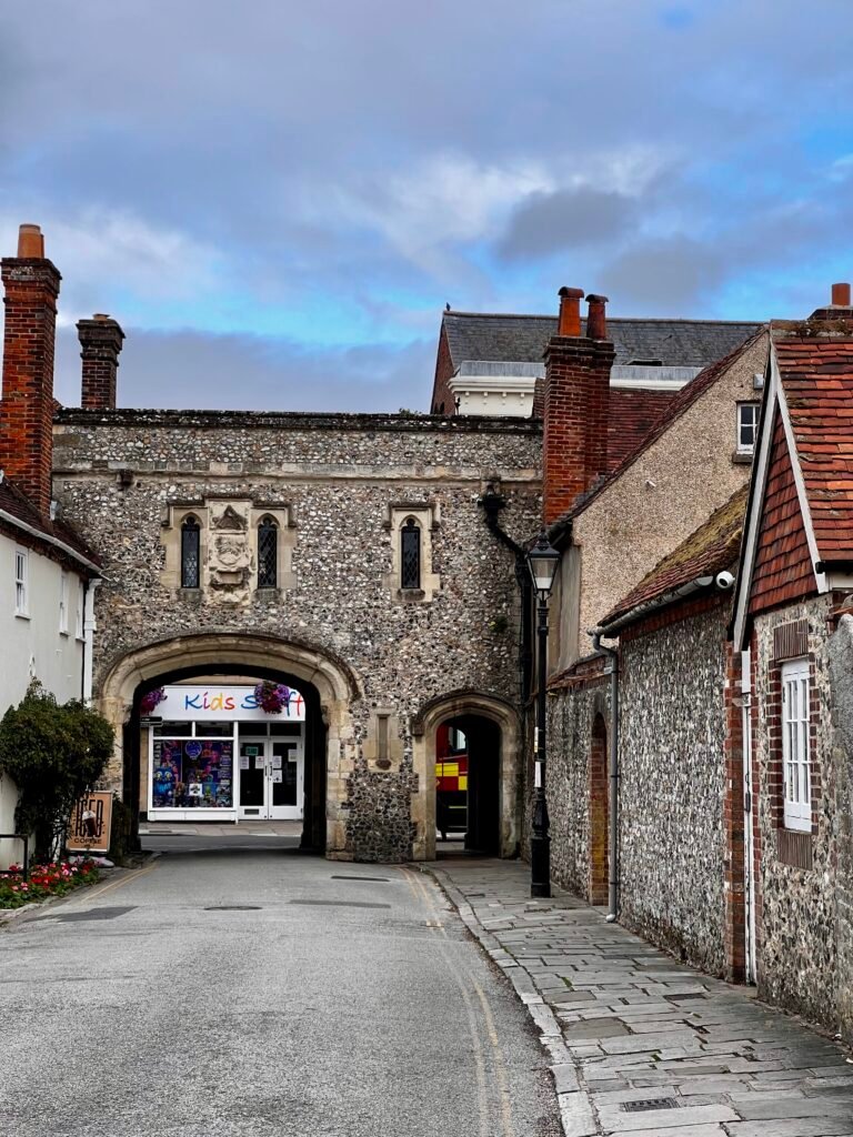 Historic stone gateway spanning a narrow street in Chichester