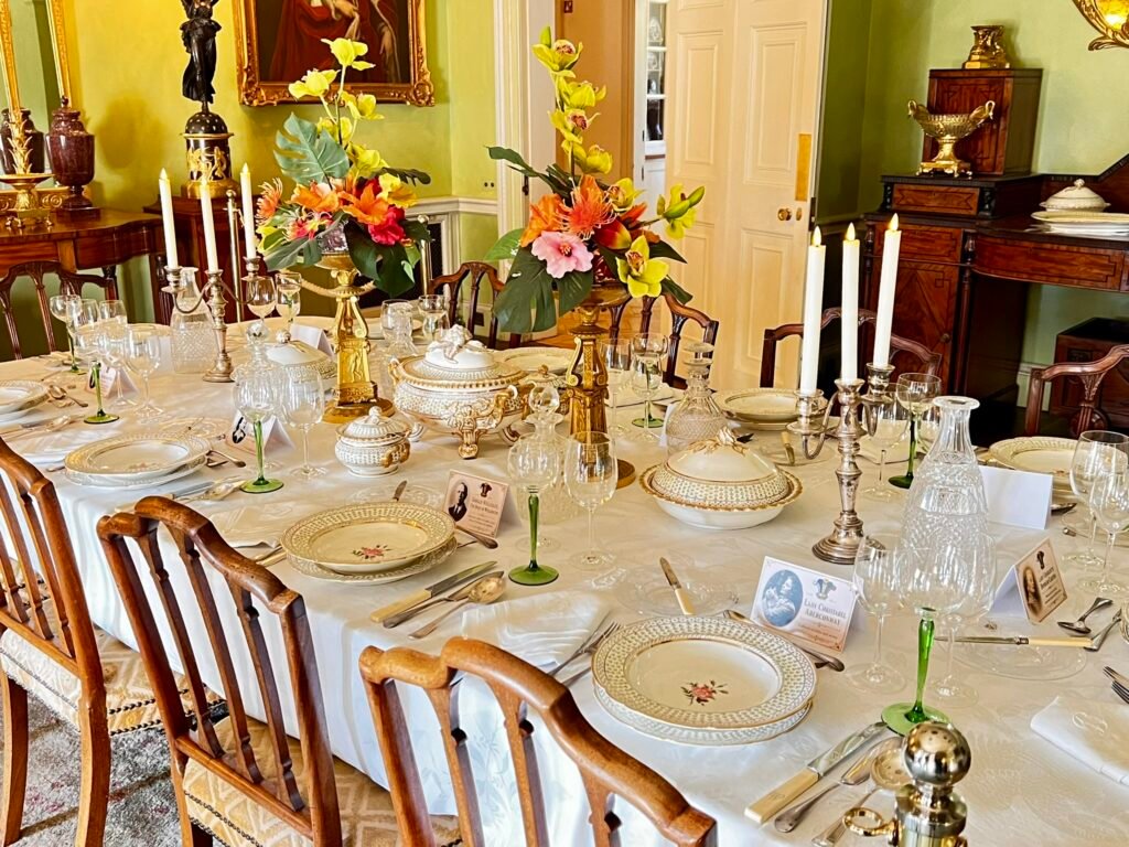 Historic dining room and laid table inside Hinton Ampner