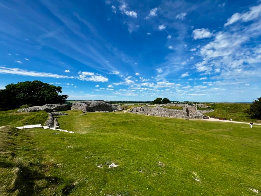 Old Sarum castle ruins and earthworks under a dramatic blue sky near Salisbury