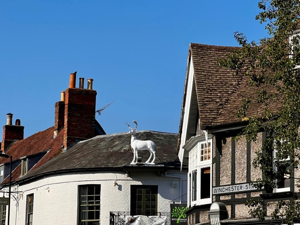 White stag sign above historic buildings in Whitchurch Hampshire
