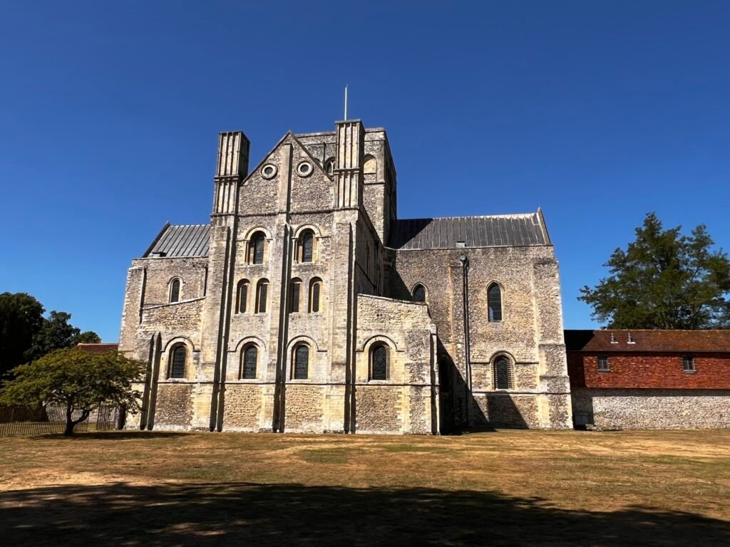 Monumental Norman stone façade of the Church of St Cross in Winchester.
