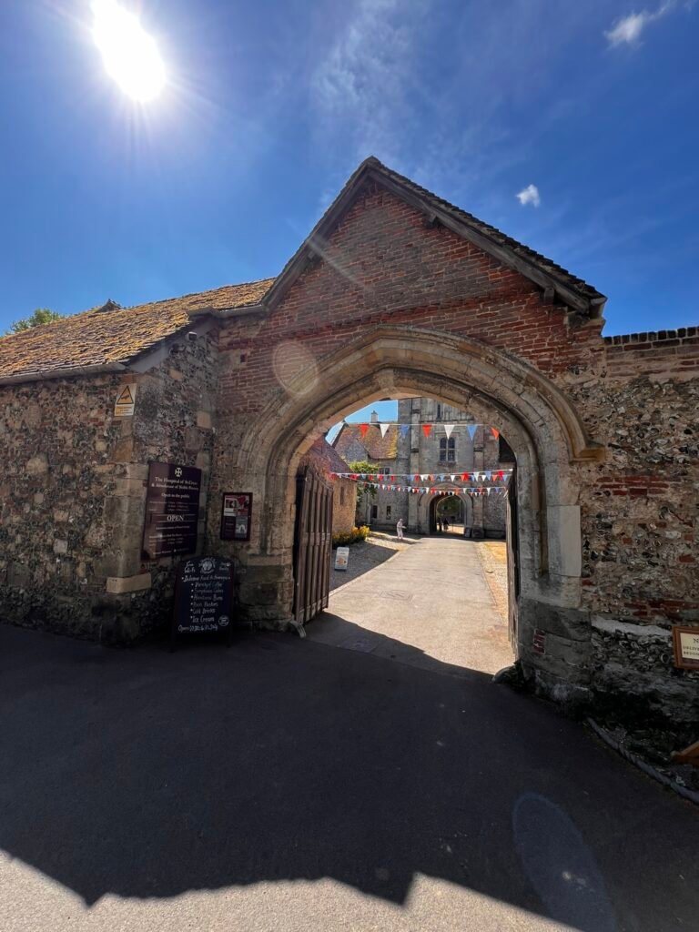 Historic stone entrance gateway leading into the Hospital of St Cross in Winchester.