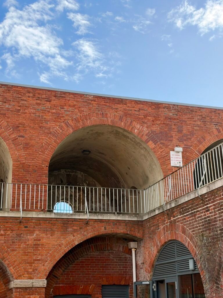 Red-brick arches and upper walkway in Portsmouth's historic Hotwalls area