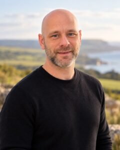 Portrait of Joseph Jay, founder of One More Stop, with a coastal backdrop.