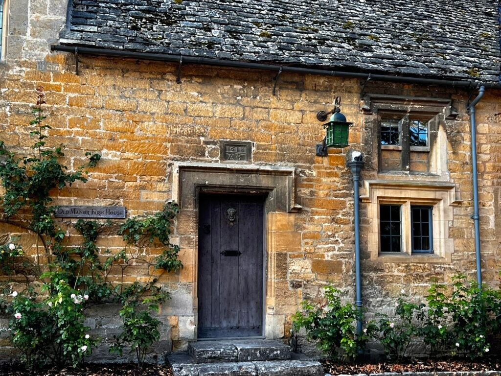 Historic wooden doorway and 1618 datestone at Old Manor Farmhouse in Stanton