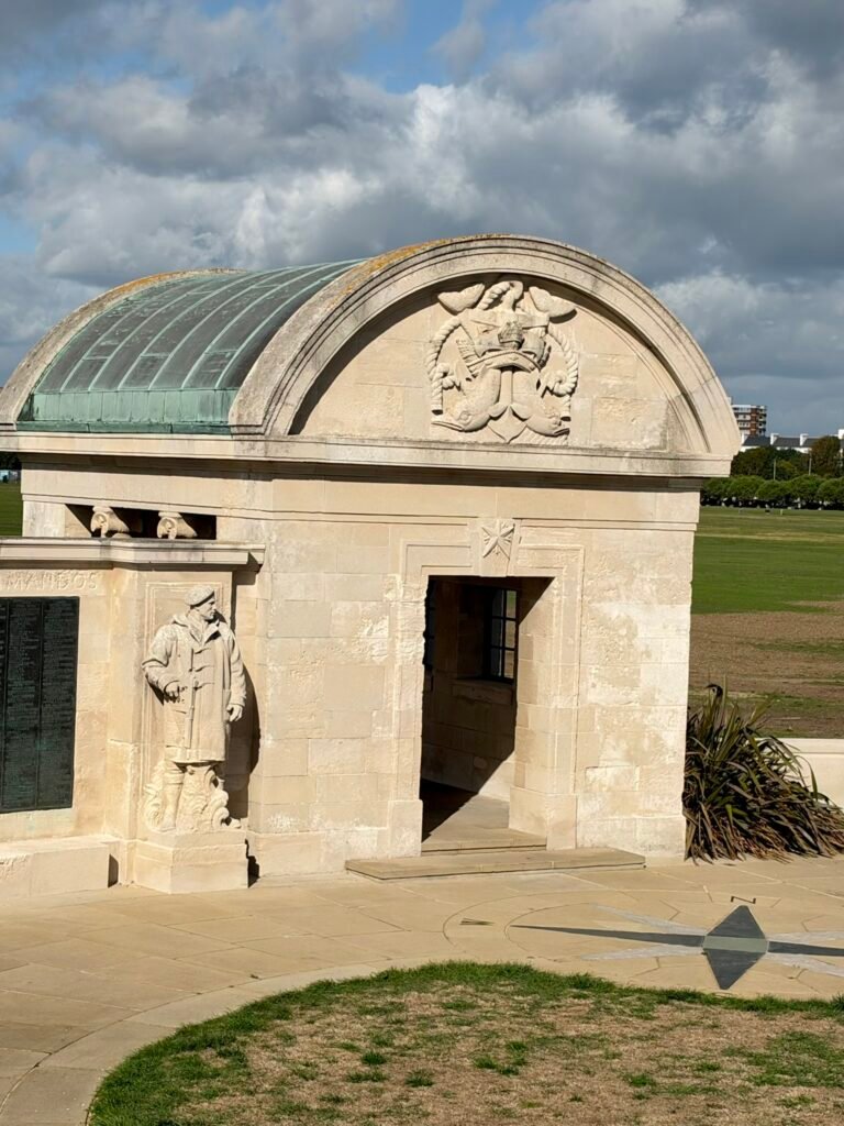 Copper-roofed stone shelter with naval sculpture at Portsmouth Naval Memorial