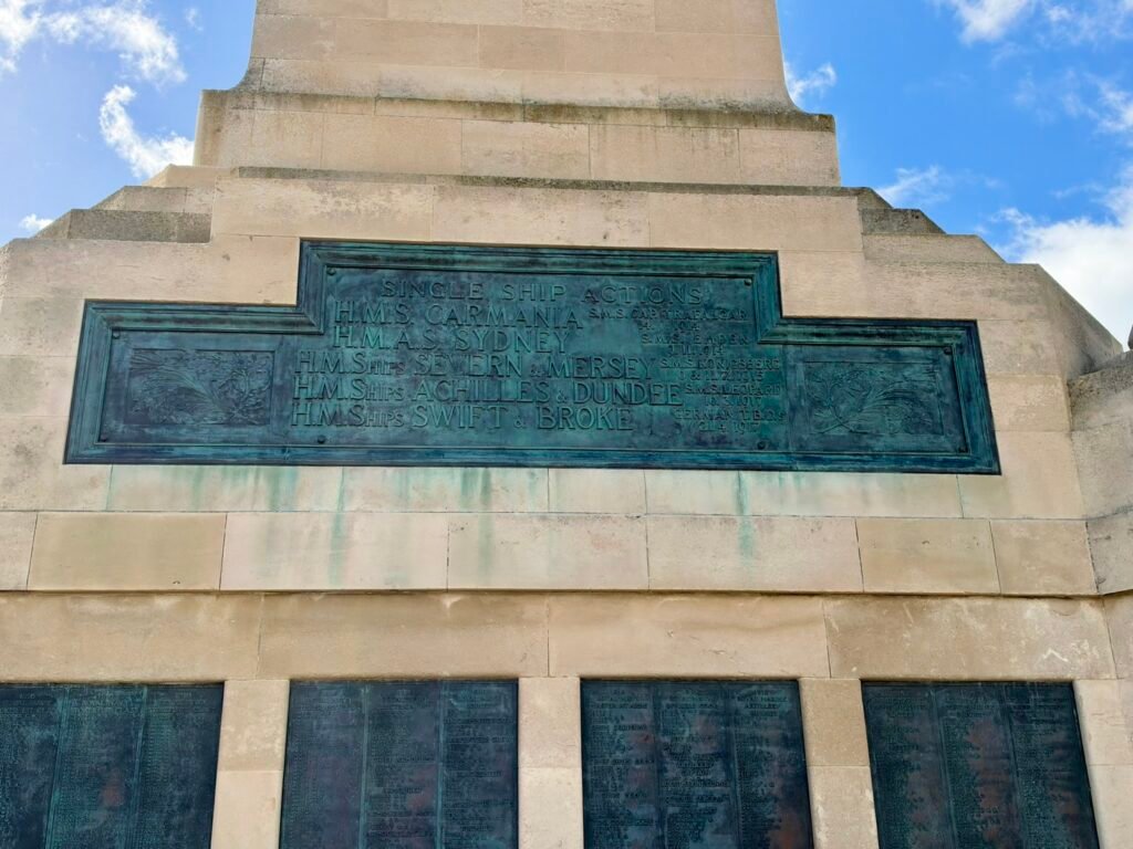 Bronze Single Ship Actions inscription above naval commemorative name panels in Portsmouth