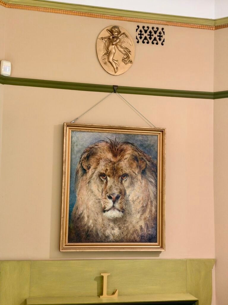 Framed painting of a lion's head displayed in the Green Room at Russell-Cotes Museum
