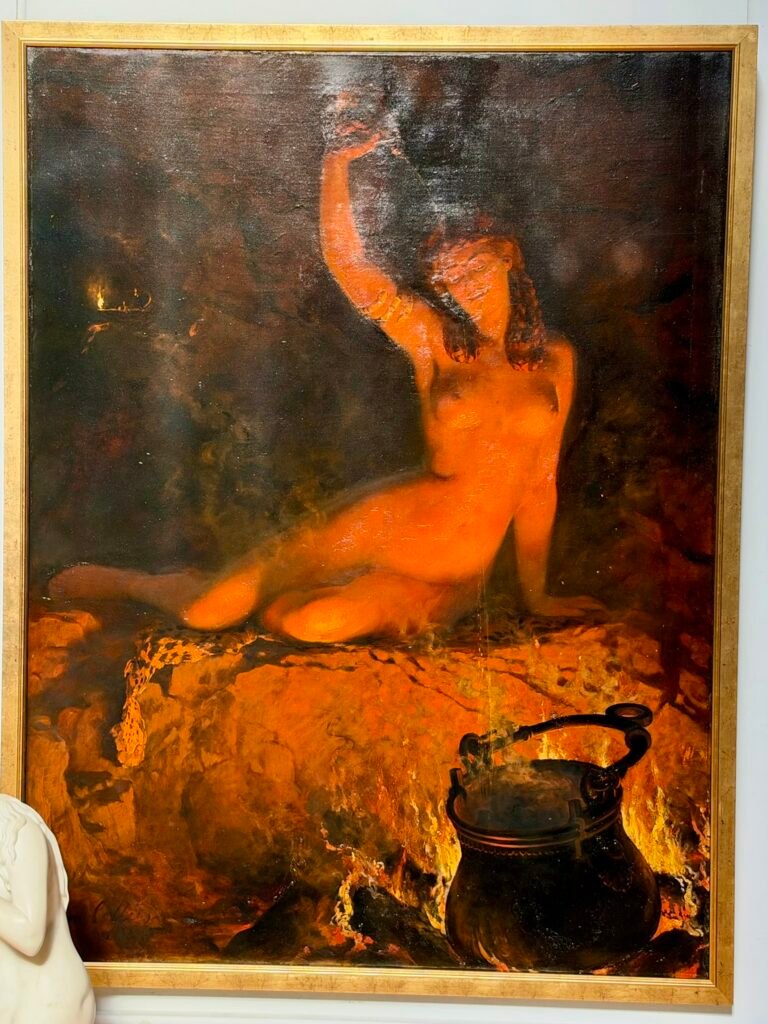 John Collier's An Incantation showing a glowing figure beside a fire-lit cauldron at Russell-Cotes