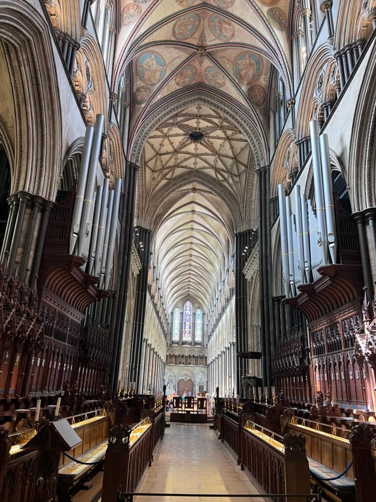Painted vaulted ceiling and towering organ pipes inside Salisbury Cathedral