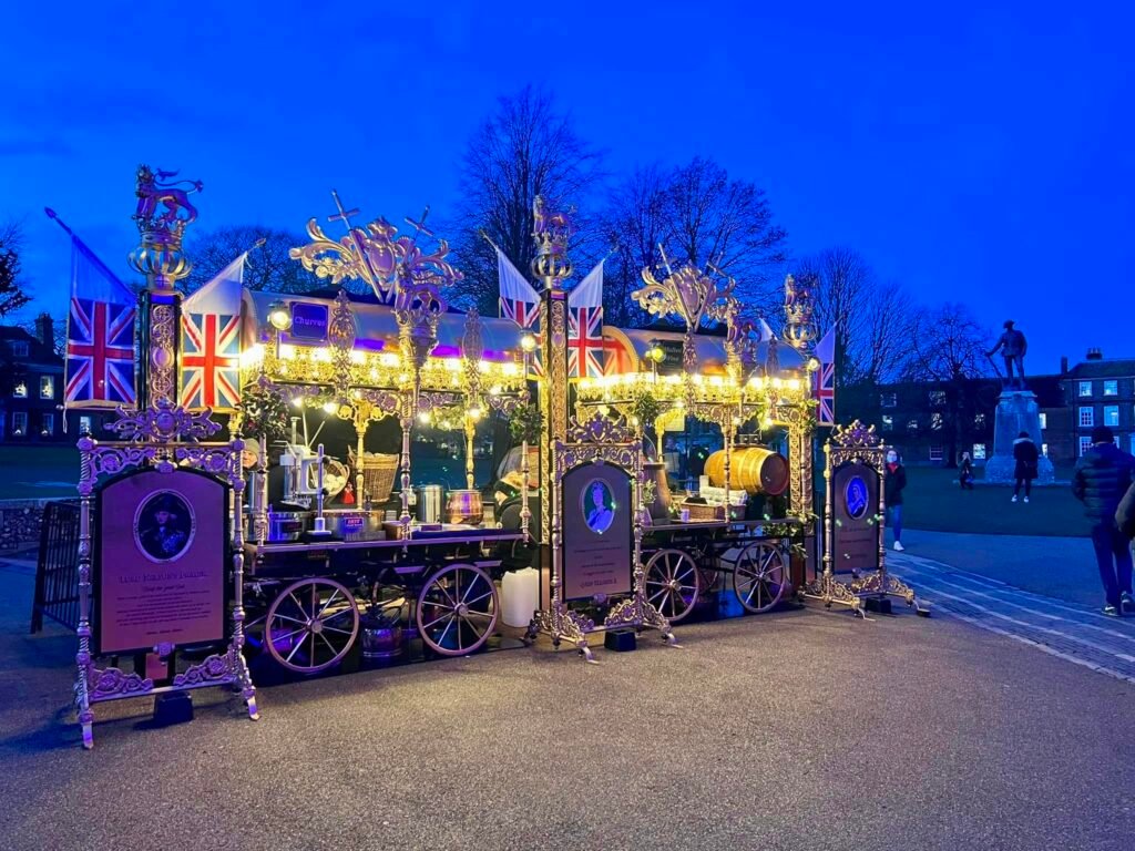 Illuminated festive market stalls at dusk