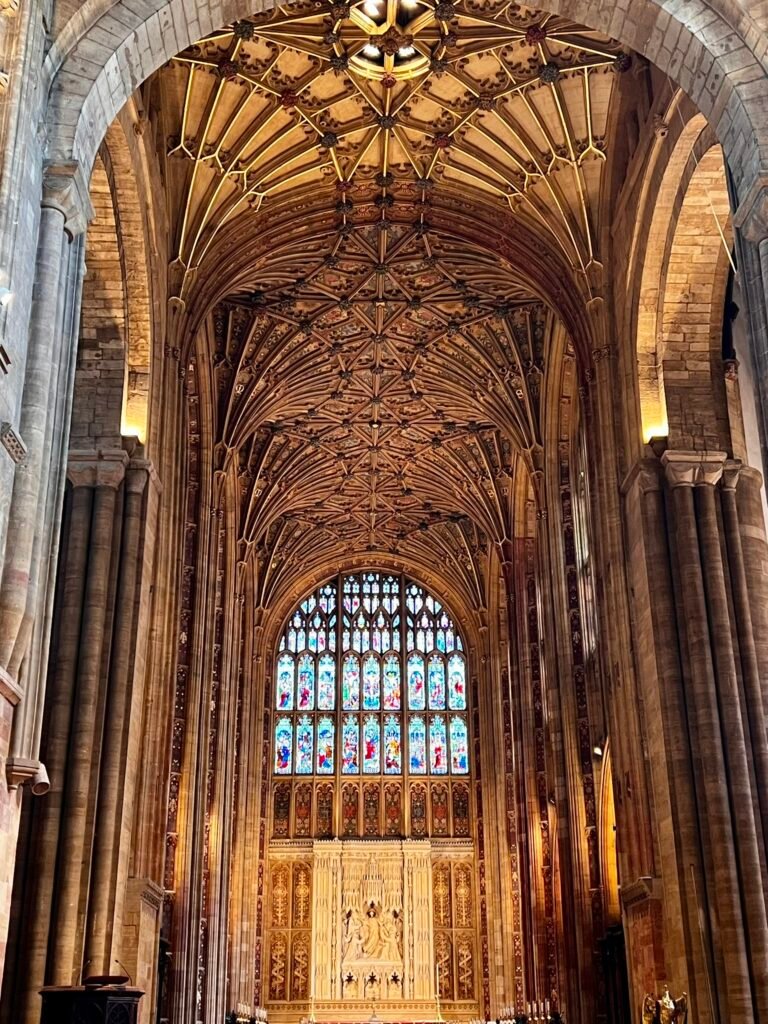 Sherborne Abbey interior with east window and ornate fan-vaulted ceiling