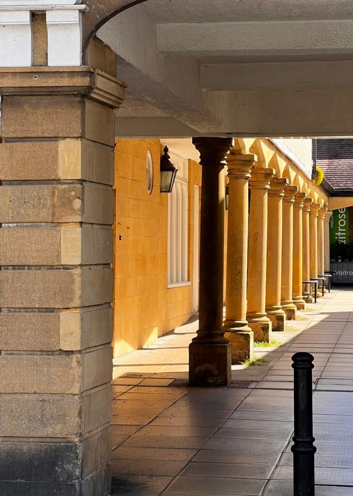 Covered walkway with stone columns in Sherborne town centre