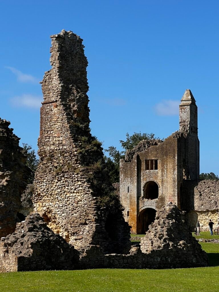 Tall ruined wall in front of the surviving gatehouse at Sherborne Old Castle