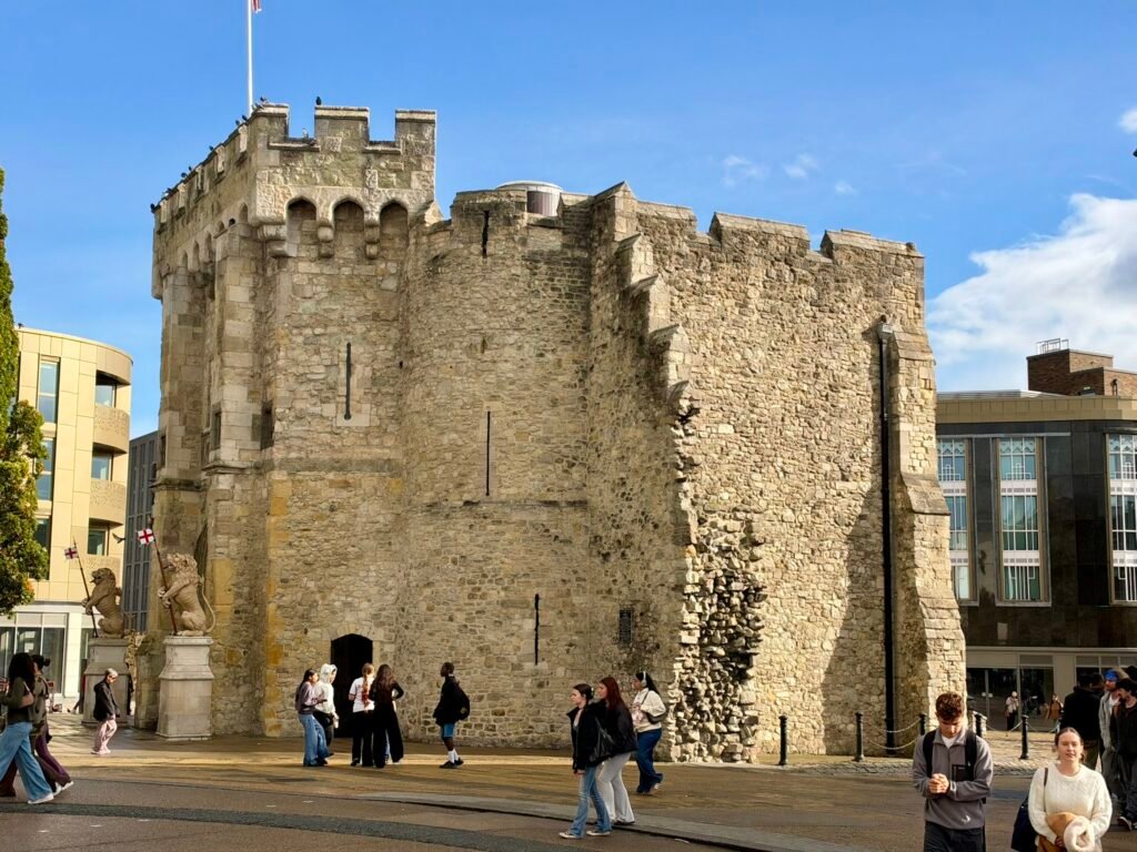 Southampton's medieval Bargate with its stone walls and visitors beneath a blue sky