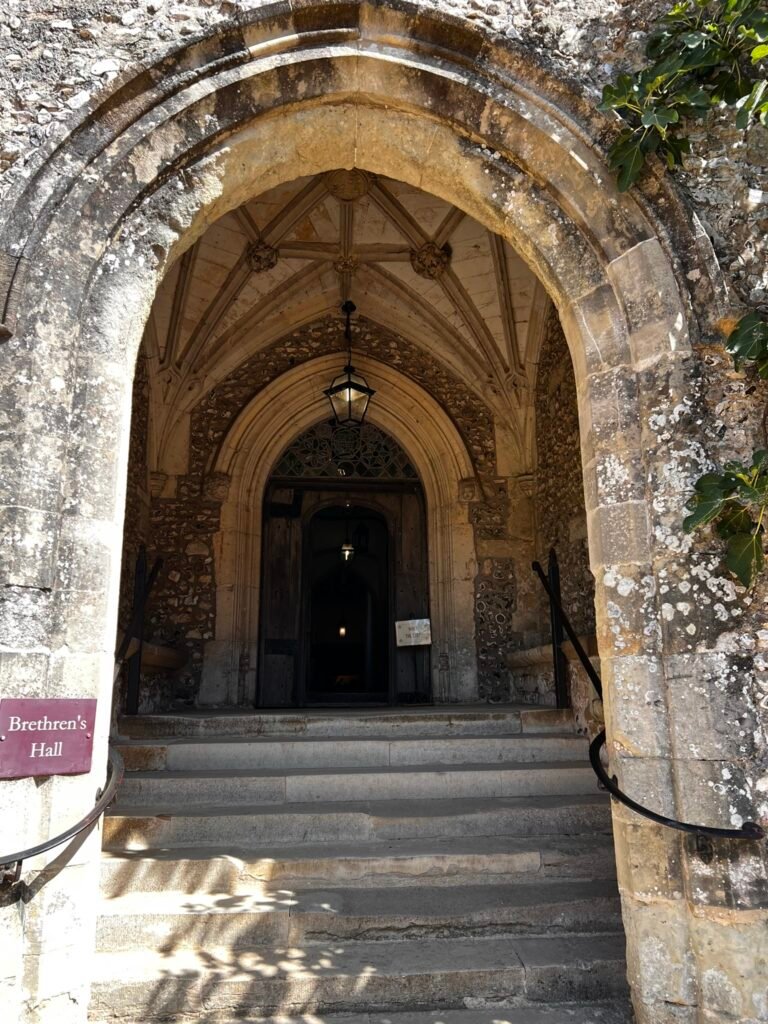 Stone steps and arched entrance to the Brethren's Hall at St Cross, Winchester.
