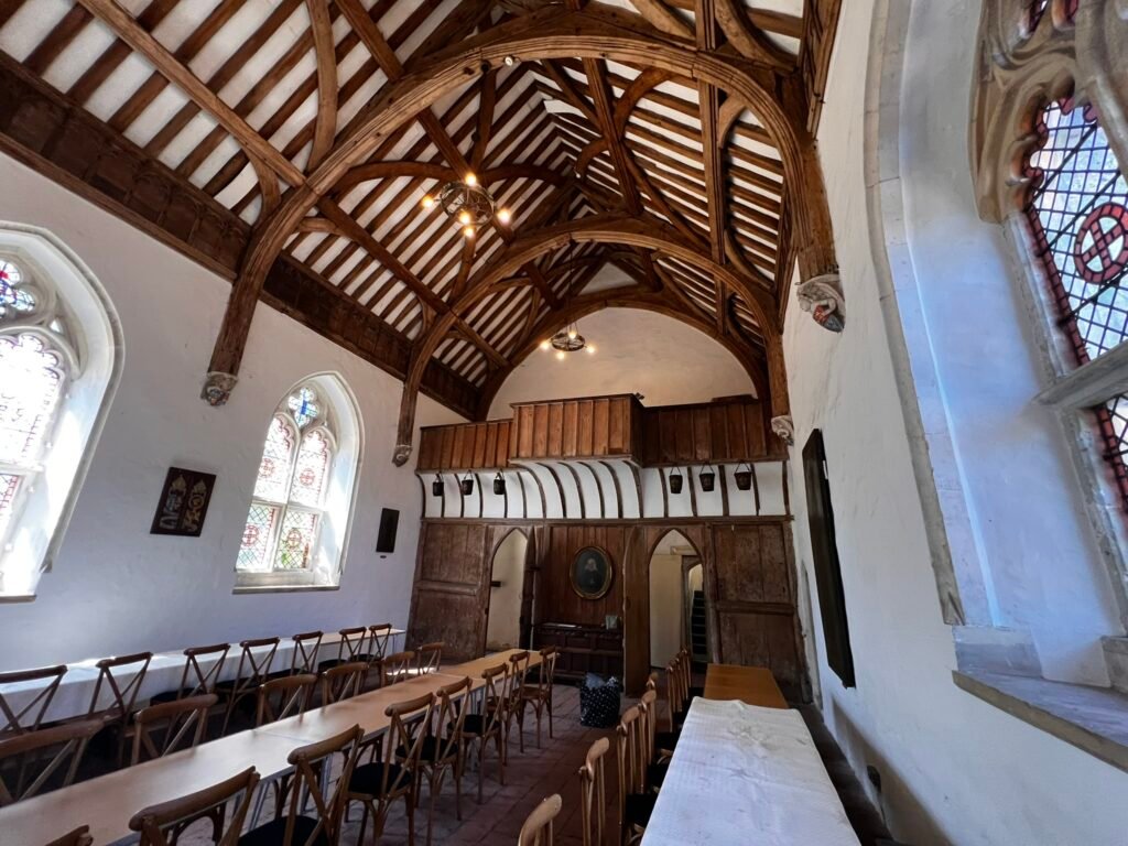 Long tables beneath the timber roof inside the Brethren's Hall at St Cross.