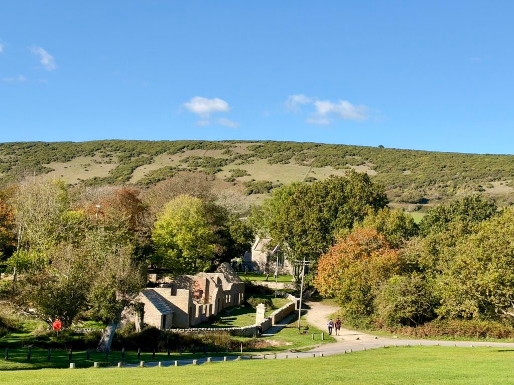 Wide view over the ruins and church of Tyneham village beneath the Purbeck Hills in Dorset