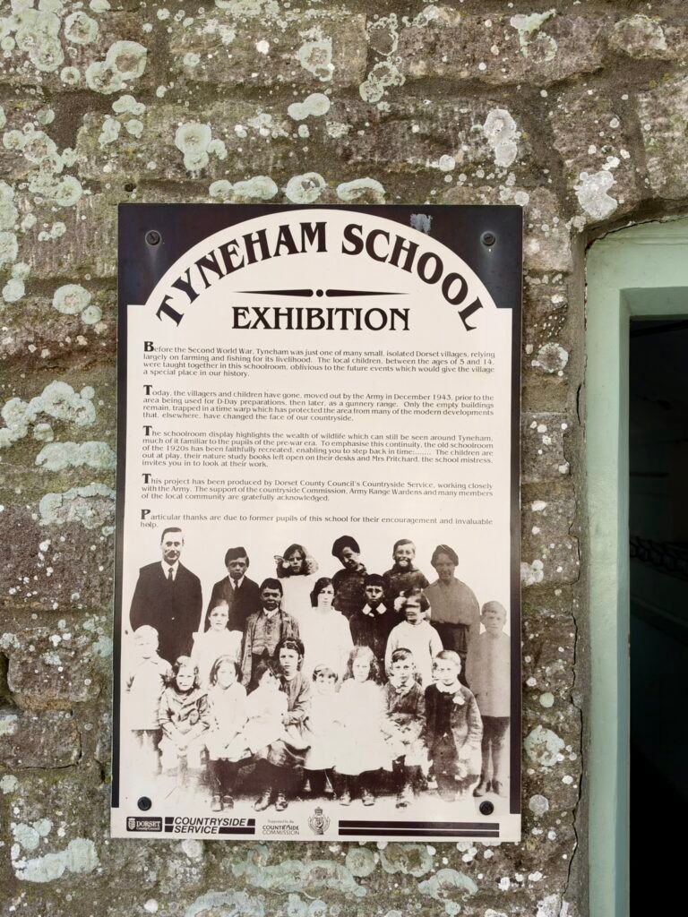 Tyneham School exhibition panel showing a historic class photograph and the village’s past