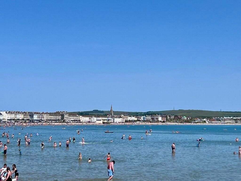Weymouth Beach and bay with swimmers and seafront buildings